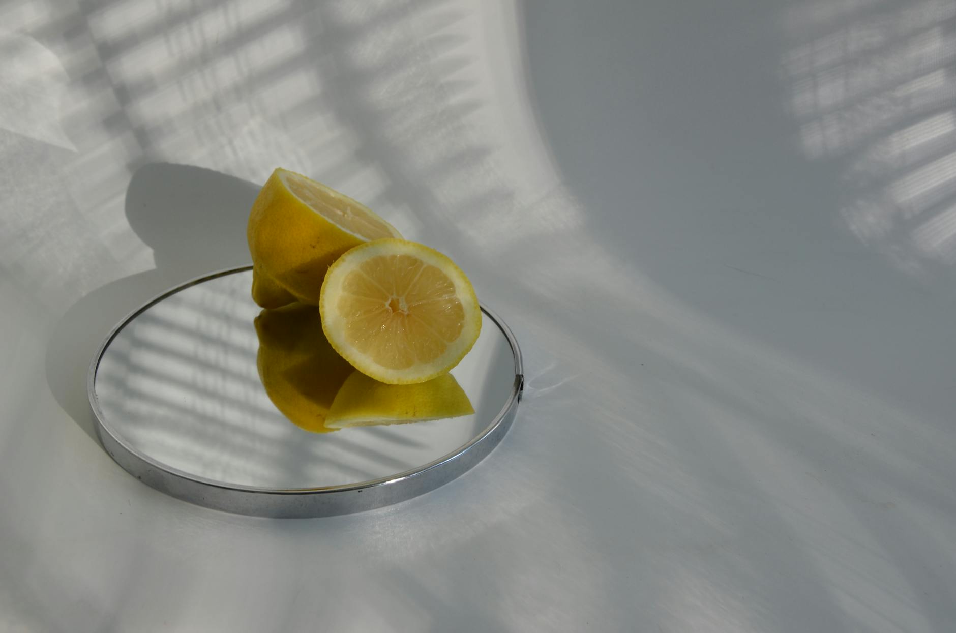 A teal clitoral vibrator on soft white silk fabric, ready for intimate use.