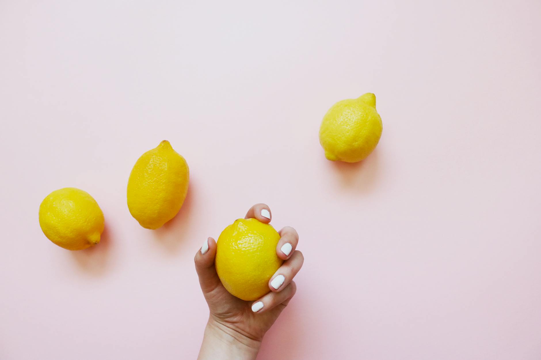 Fresh lemons on soft pink background, representing fresh starts and new exploration