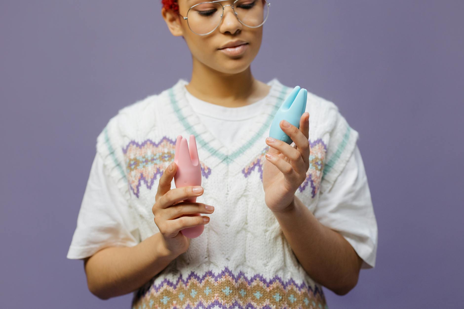 Woman holding colorful vibrators, exploring clitoral sensation recovery