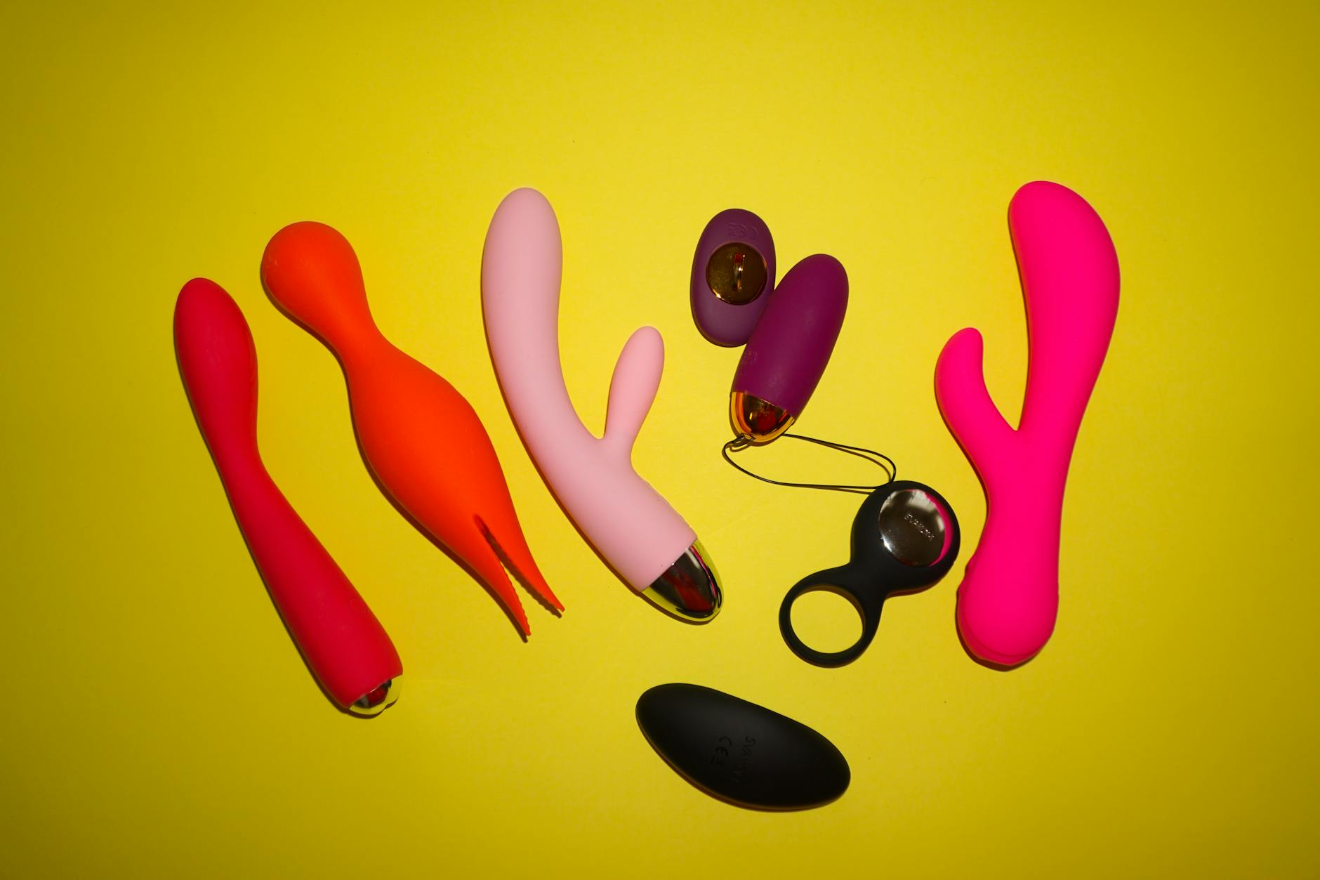 Colorful lemon clitoral vibrators arranged on a bright yellow background